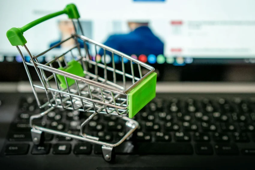 small toy shopping cart on top of keyboard